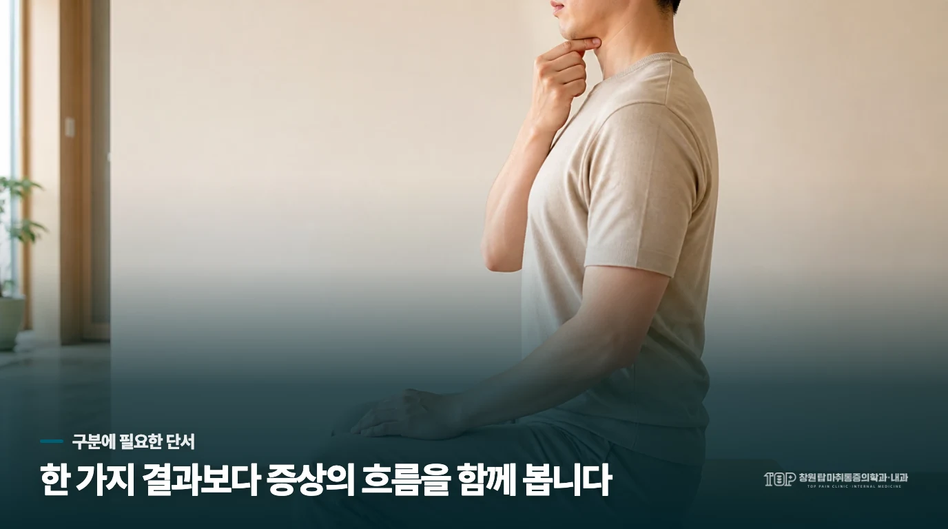 의자에 앉아 턱 아래에 손가락을 가볍게 댄 사람