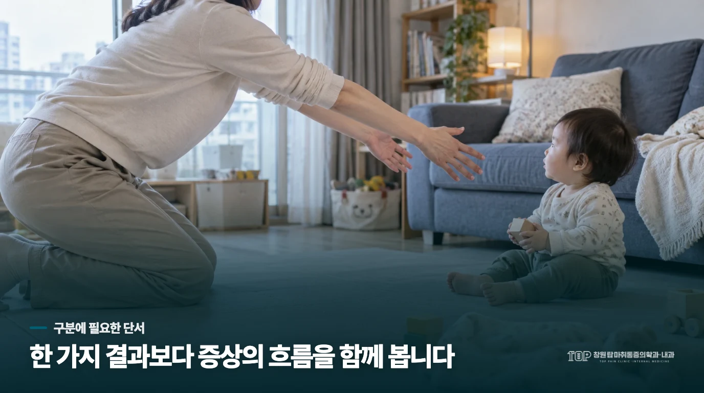 침대 곁에서 손목을 받치는 사람의 손